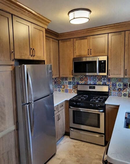 Before and after kitchen renovation by American Home Remodeling Service - Mexican tile backsplash